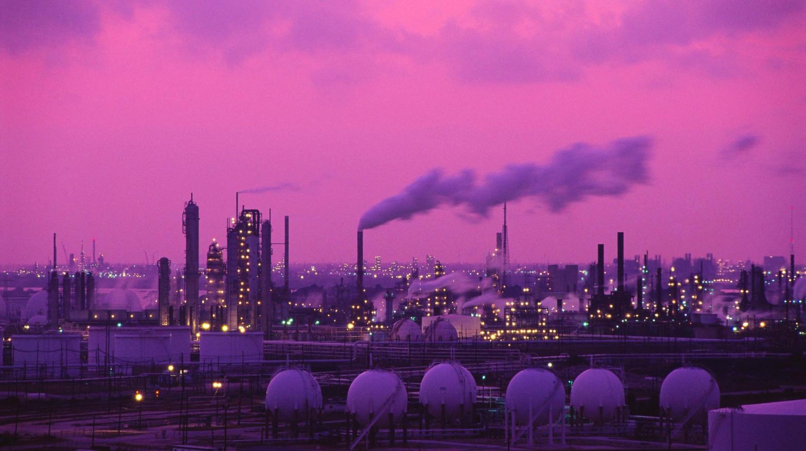 The sun sets over an Exxon oil refinery. (Photo: Greg Smith/Corbis, Getty Images)