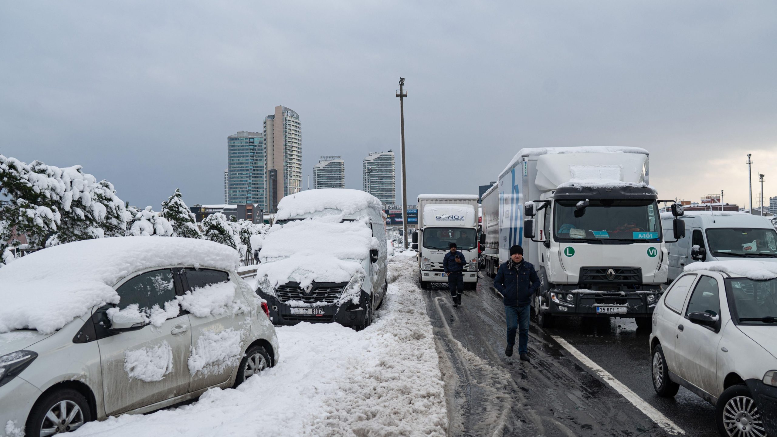 Men walk past vehicles stranded on the highway after heavy snowfall at the Basaksehir district in Istanbul. (Photo: Yasin Akgul/AFP, Getty Images)