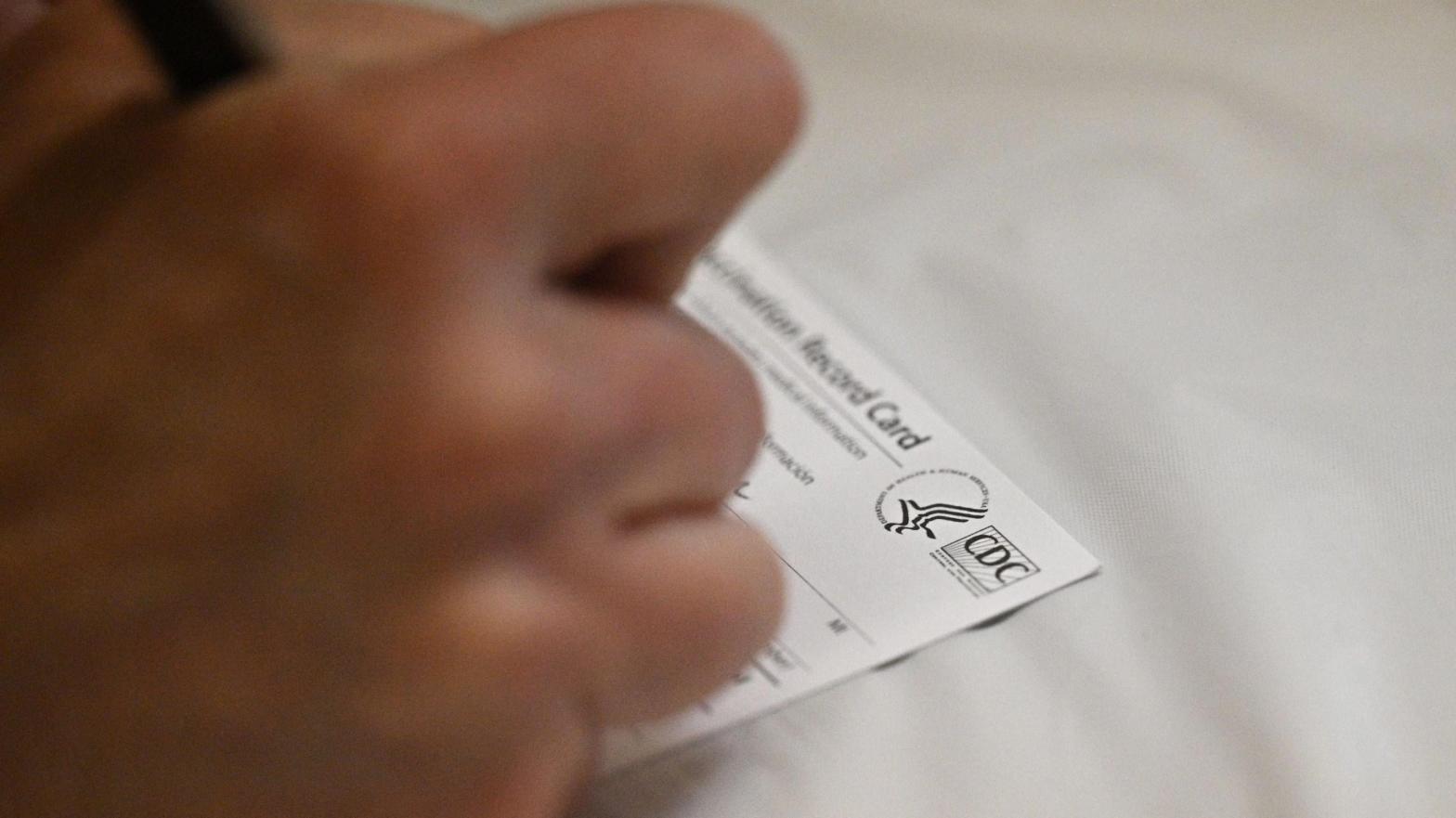 A person filling out a Centres for Disease Control and Prevention vaccination card; used here as stock photo. (Photo: Robyn Beck / AFP, Getty Images)
