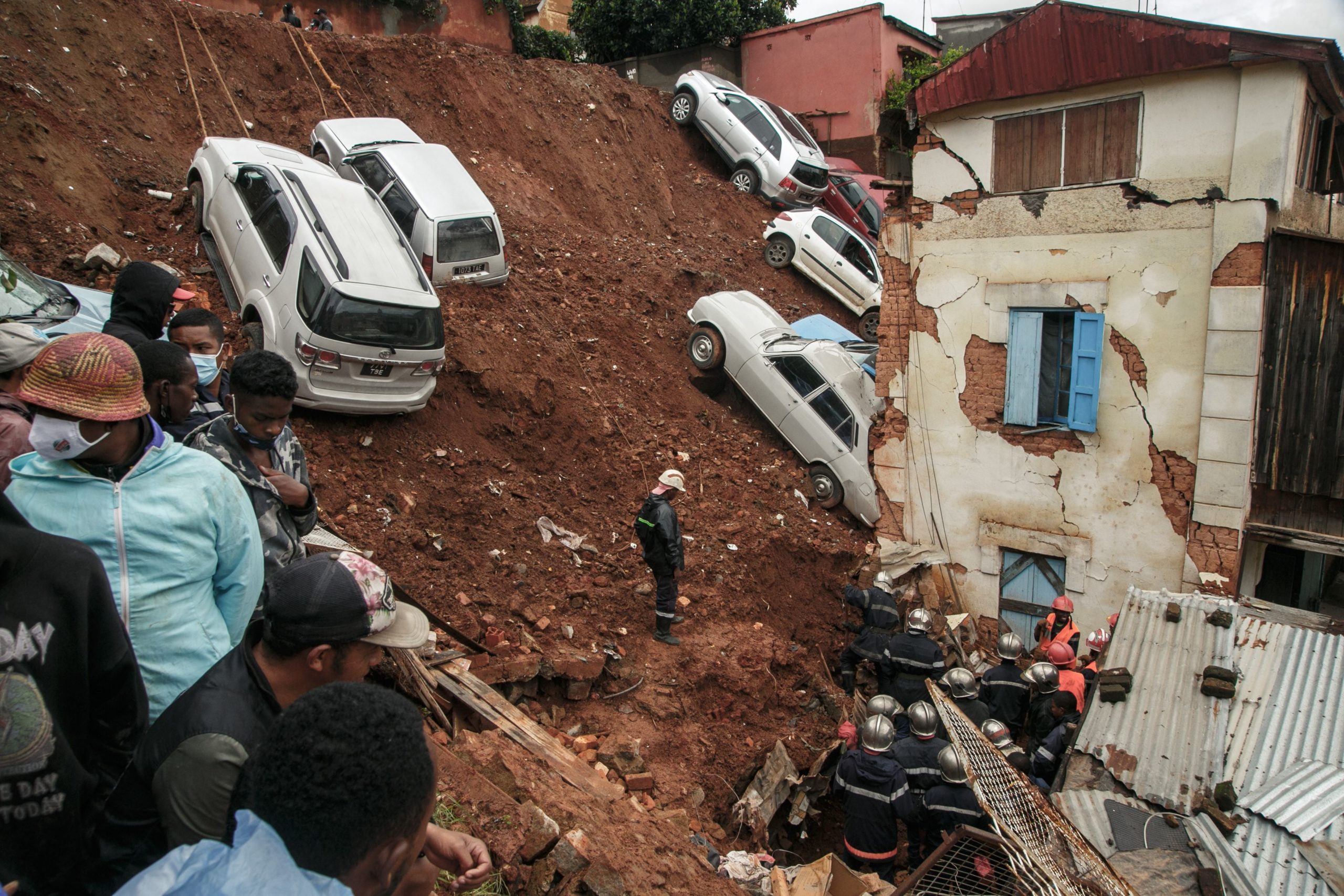 Firefighters search through rubble after a car park housing several private cars collapsed on houses following the heavy rains of the last few days in the Ankadifotsy neighbourhood of Antananarivo on January 24. (Photo: RIJASOLO/AFP, Getty Images)