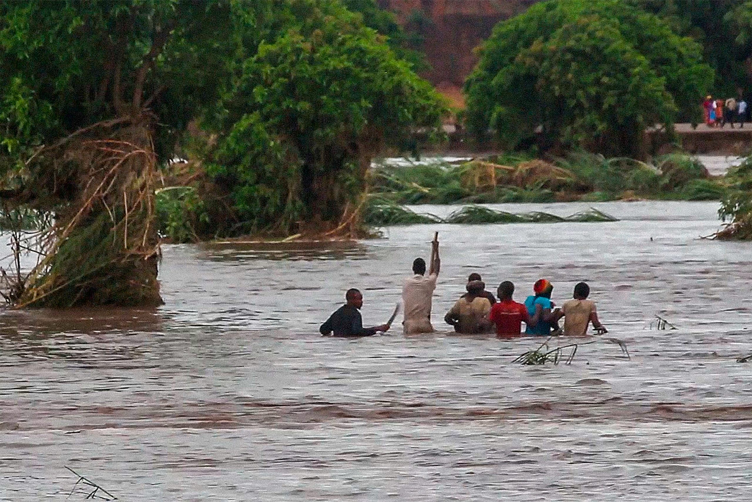 People walk on a road swept by flooding waters in Chikwawa, Malawi, Tuesday Jan. 25. (Photo: AP Photo, AP)