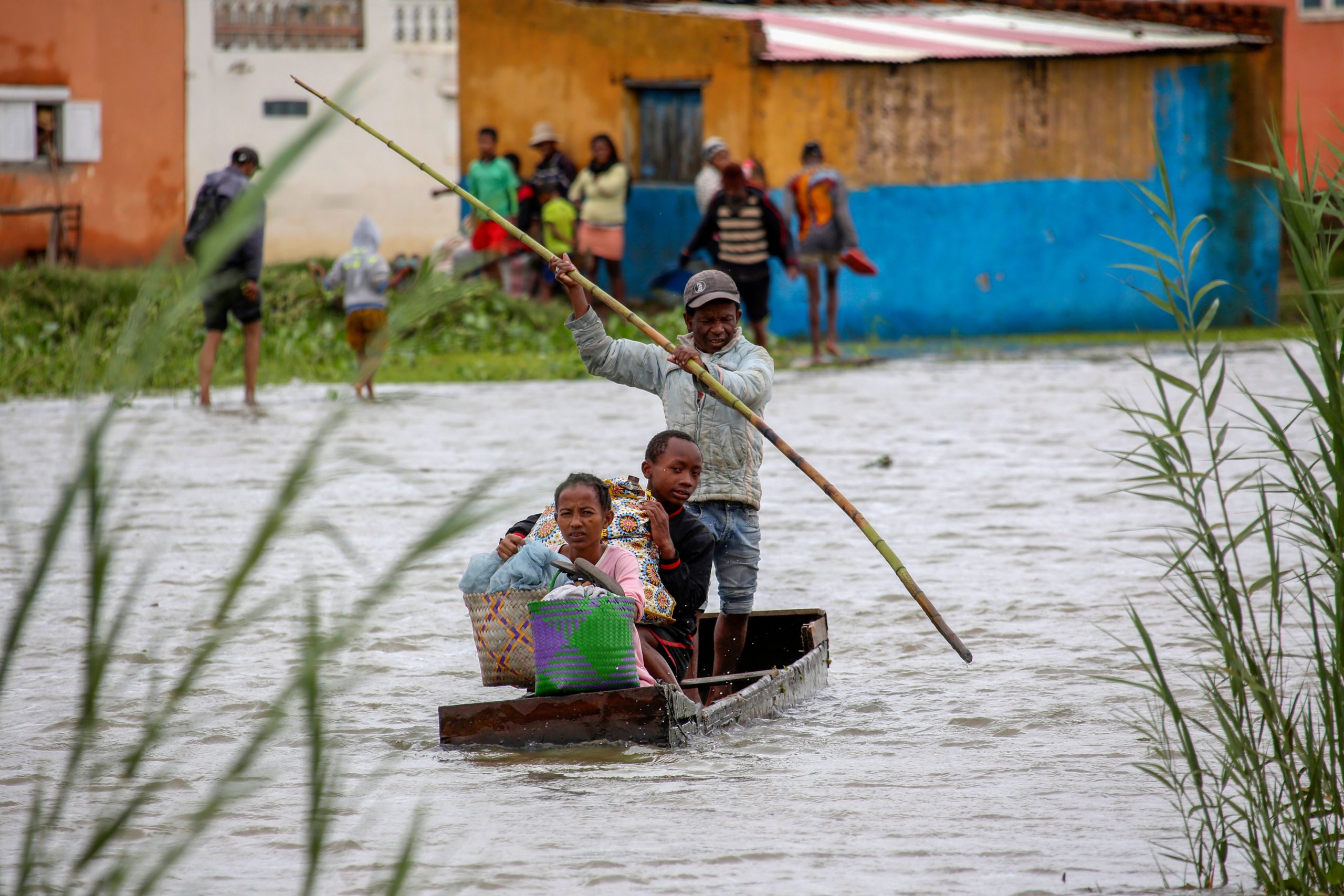 A family take their belongings after their home was flooded after a week long of heavy rain, in Antananarivo, Madagascar, Monday, Jan. 24. (Photo: Alexander Joe, AP)