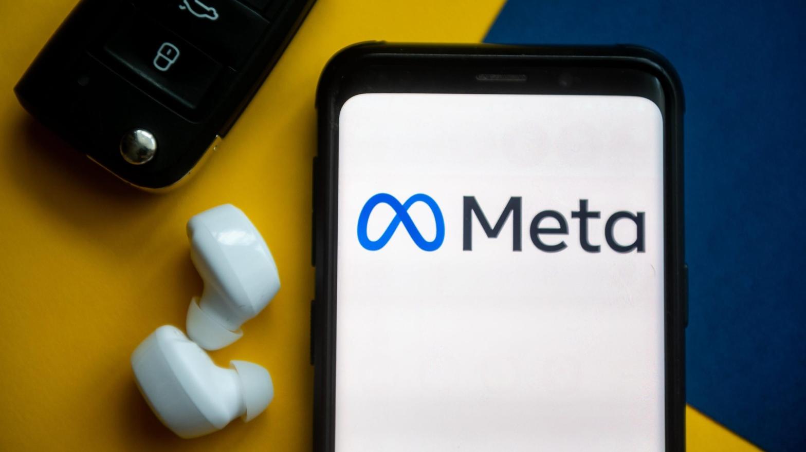 The Meta logo displayed on a smartphone next to wireless earphones and... car keys, for some reason. Used here as stock photo. (Photo: Mateusz Slodkowski / SOPA Images / LightRocket via Getty Images, Getty Images)