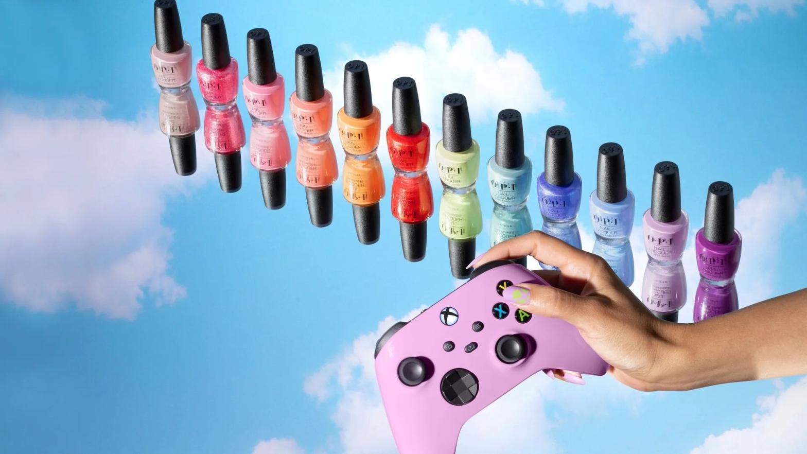 A row of brightly coloured nail polishes. A disembodied hand is holding a pink Xbox controller on a sky blue background.