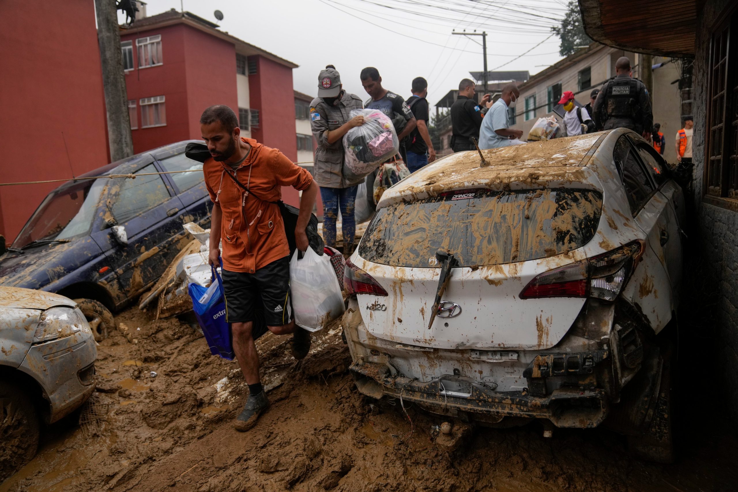 Residents recover belongs from their homes destroyed by mudslides. (Photo: Silvia Izquierdo, AP)