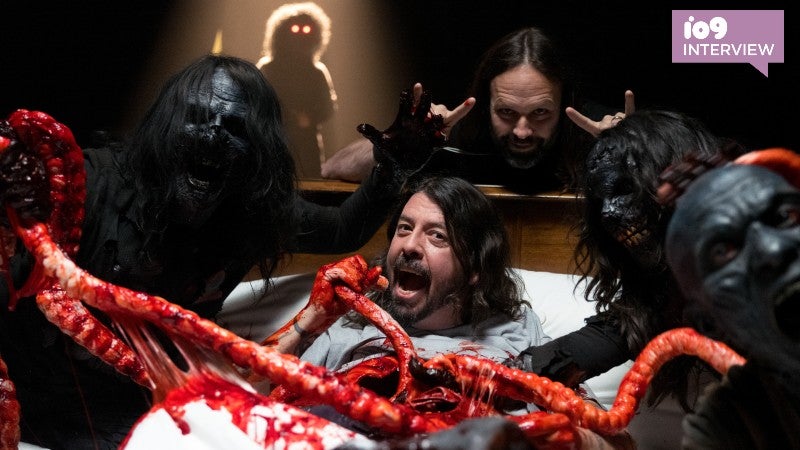 Studio 666 director BJ McDonnell throwing up the horns behind Foo Fighters front man Dave Grohl... and some demons. (Image: Open Road Films/Andrew Stuart)