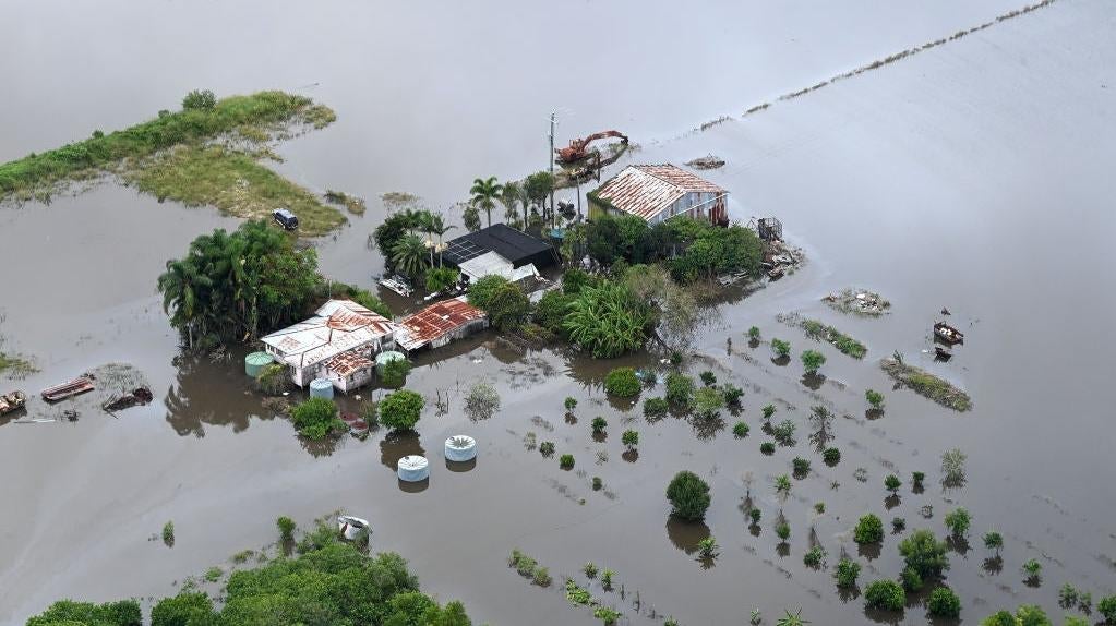 A farm house is surrounded by floodwaters in the town of Bli Bli on February 27, 2022.  (Photo: Bradley Kanaris, Getty Images)