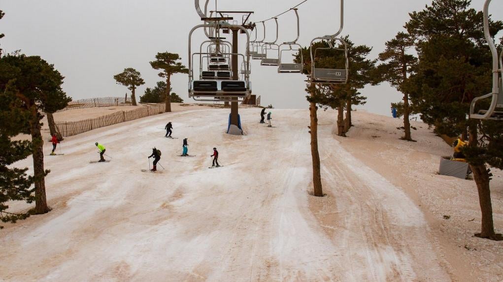 People ski at the Navacerrada ski resort on March 16, 2022, in Madrid, Spain on the second consecutive day a reddish blanket of dust has hovered over the country.  (Photo: Rafael Bastante/Europa Press, Getty Images)