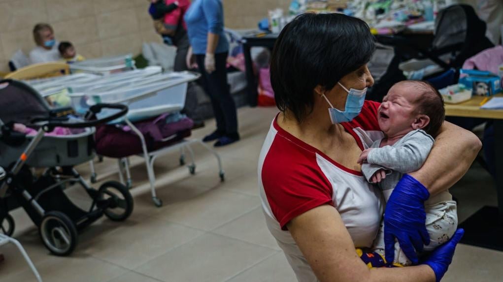 Nursing staff Svetlana Stetsiuk tries to comfort an infant in a makeshift nursery underground in the outskirts of Kyiv, Ukraine on March 20, 2022. (Photo: Marcus Yam / Los Angeles Times, Getty Images)