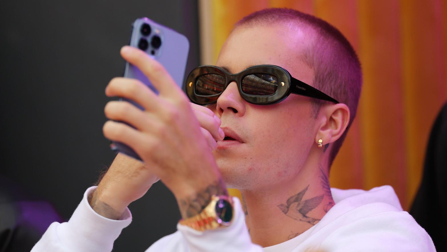 Justin Bieber on his phone at Super Bowl LVI on February 13, 2022 in Inglewood, California. (Photo: Kevin C. Cox, Getty Images)