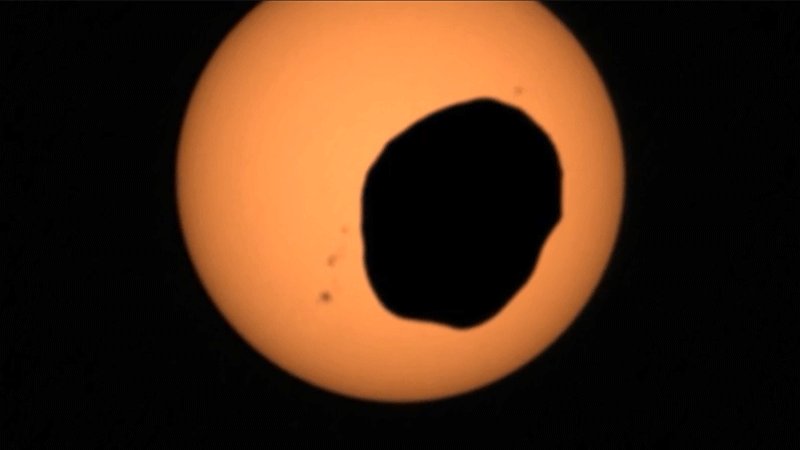 The Martian moon Phobos passes in front of the Sun in these images from NASA's Perseverance rover. (Gif: NASA/JPL-Caltech/ASU/MSSS/SSI)