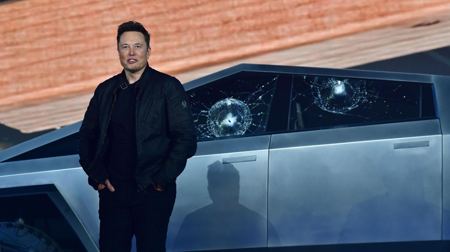 Tesla co-founder and CEO Elon Musk stands in front of the shattered windows of the newly unveiled all-electric battery-powered Tesla's Cybertruck (Photo: Frederic J. Brown, Getty Images)