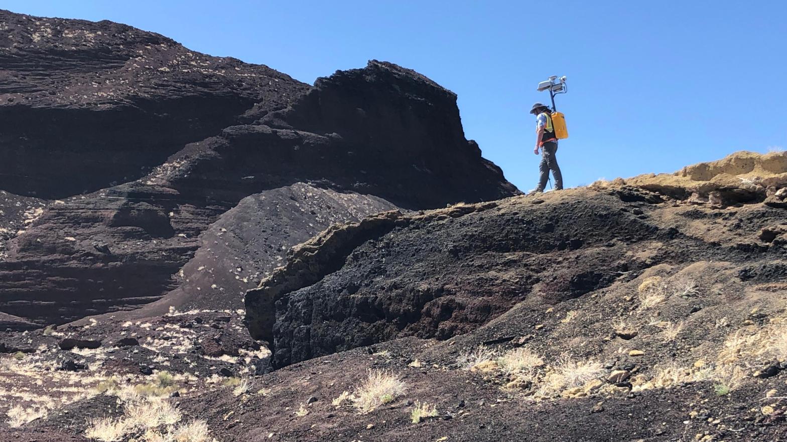 NASA Planetary Scientist Michael Zanetti testing out the backpack in Potrillo volcanic field in New Mexico. (Photo: NASA/Michael Zanetti)