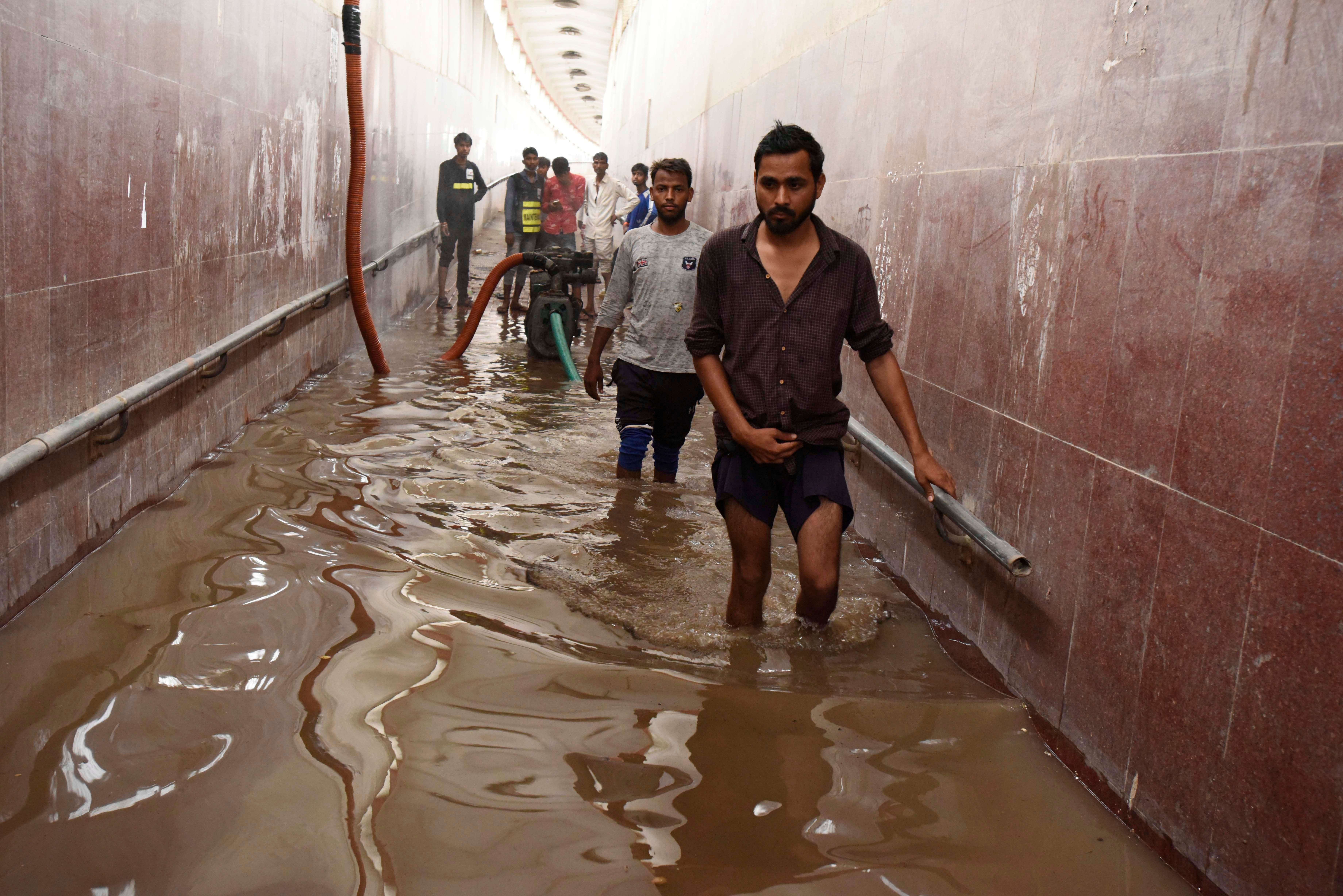 People wade across a waterlogged pedestrian subway, at National  Highway-48, in Kherki Daula near the police station on August 13,  2020 in Gurugram, India. (Photo: Parveen Kumar/Hindustan Times, Getty Images)