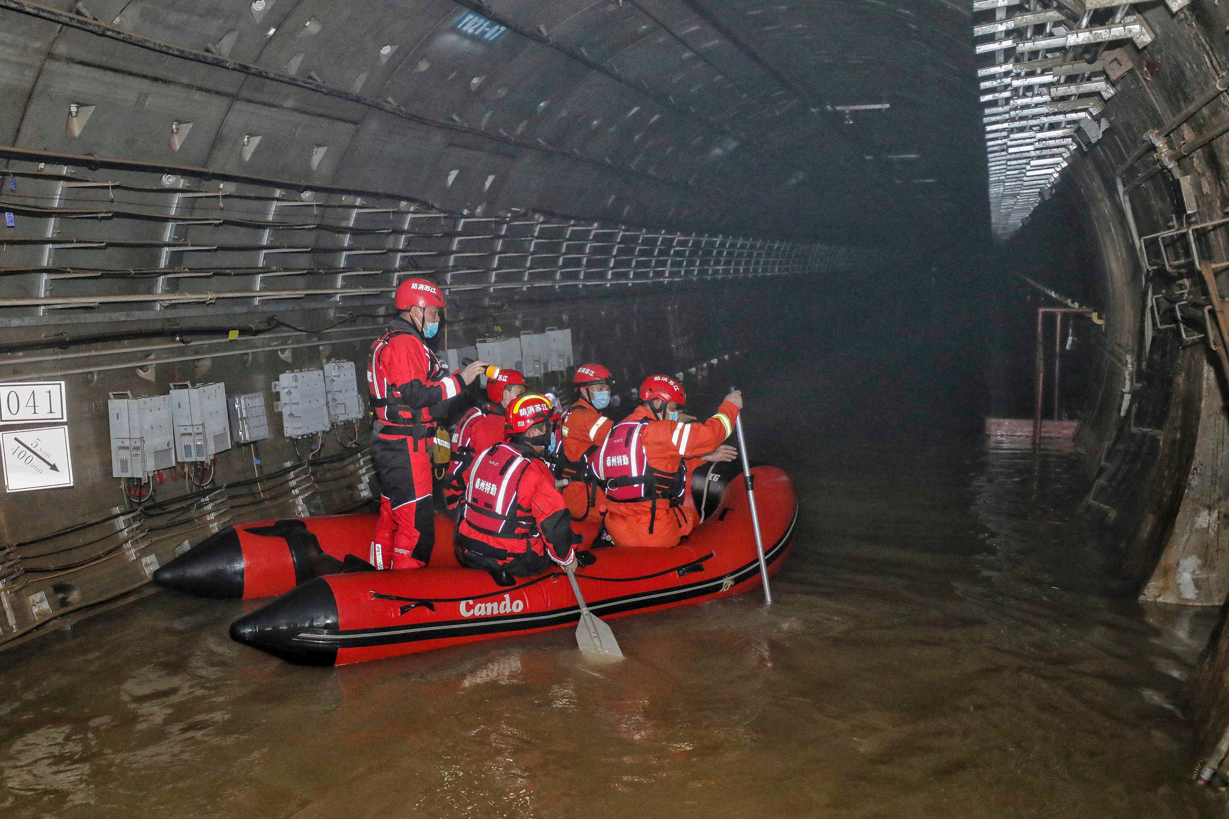 This photo taken on July 26, 2021 shows rescuers searching inside the  subway which was flooded following heavy rains in Zhengzhou, in China's  central Henan province.  (Photo: STR / AFP, Getty Images)