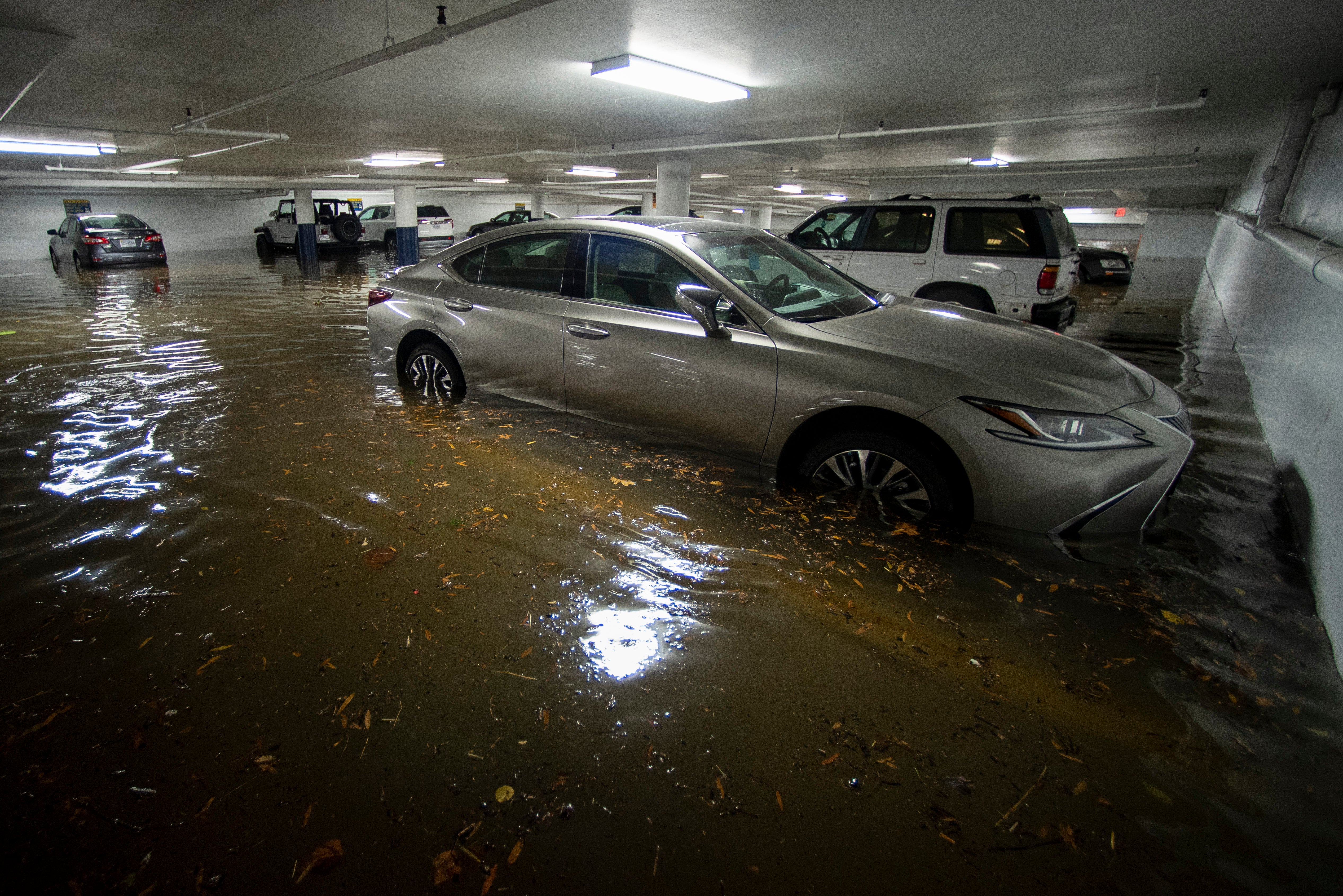 An underground parking garage floods as the Potomac River overflows its  banks in the historic Old Town section of Alexandria, Va., Friday, Oct.  29, 2021. (Photo: Cliff Owen, AP)