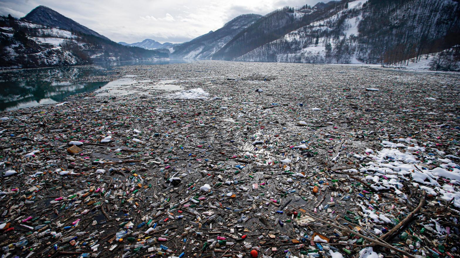 Plastic bottles and other waste float on Potpecko lake in Serbia. (Photo: Darko Vojinovic, AP)