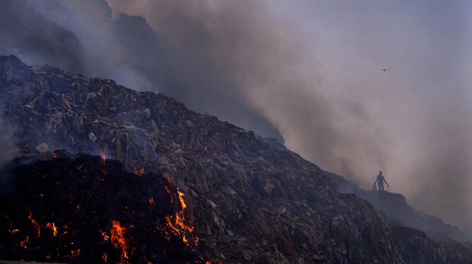 A man walks through the Bhalswa landfill as the fire rages. (Photo: Manish Swarup, AP)