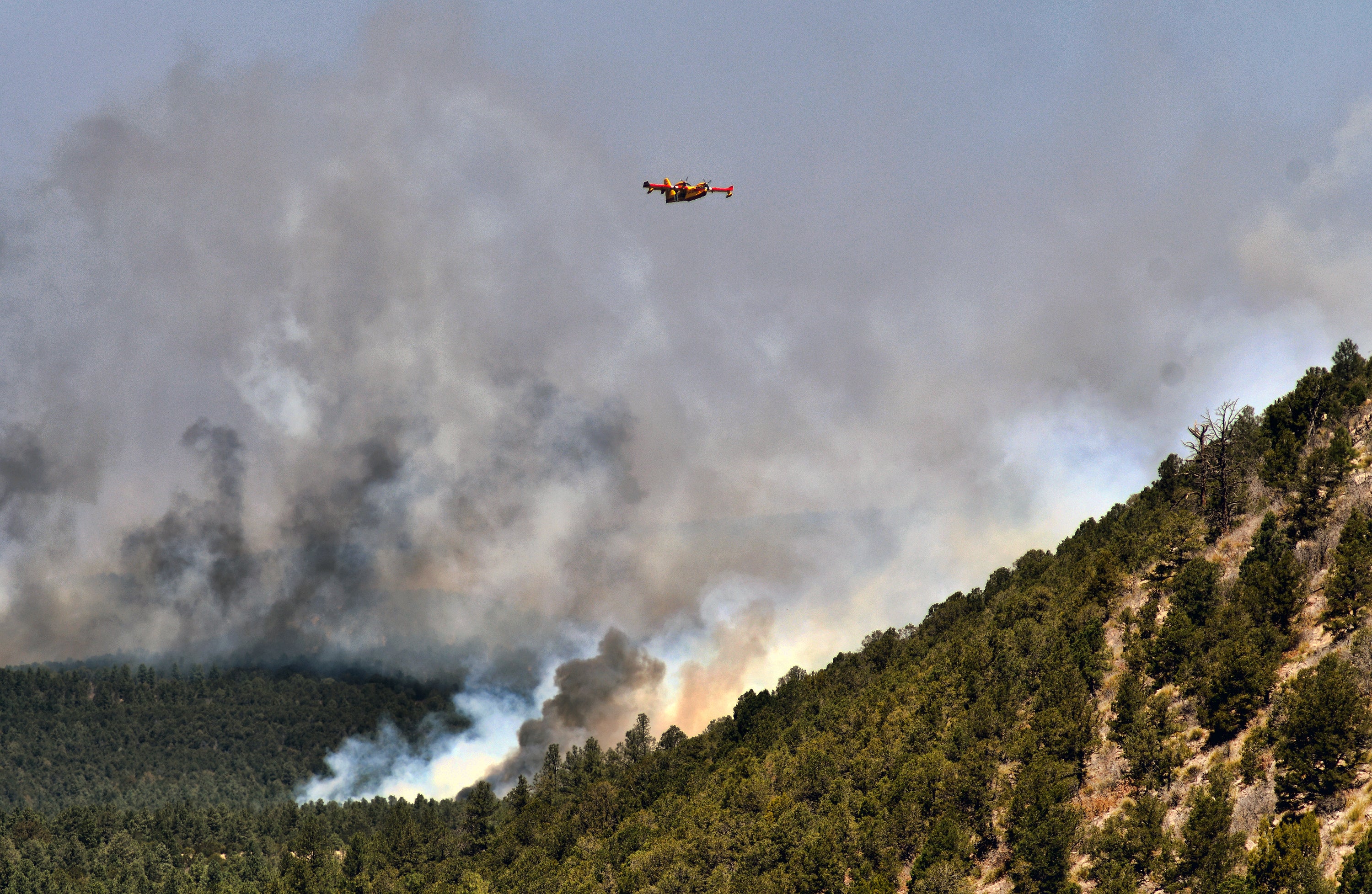 A firefighting plane flew over the fire near Las Vegas, NM on May 4. (Photo: Thomas Peripert, AP)