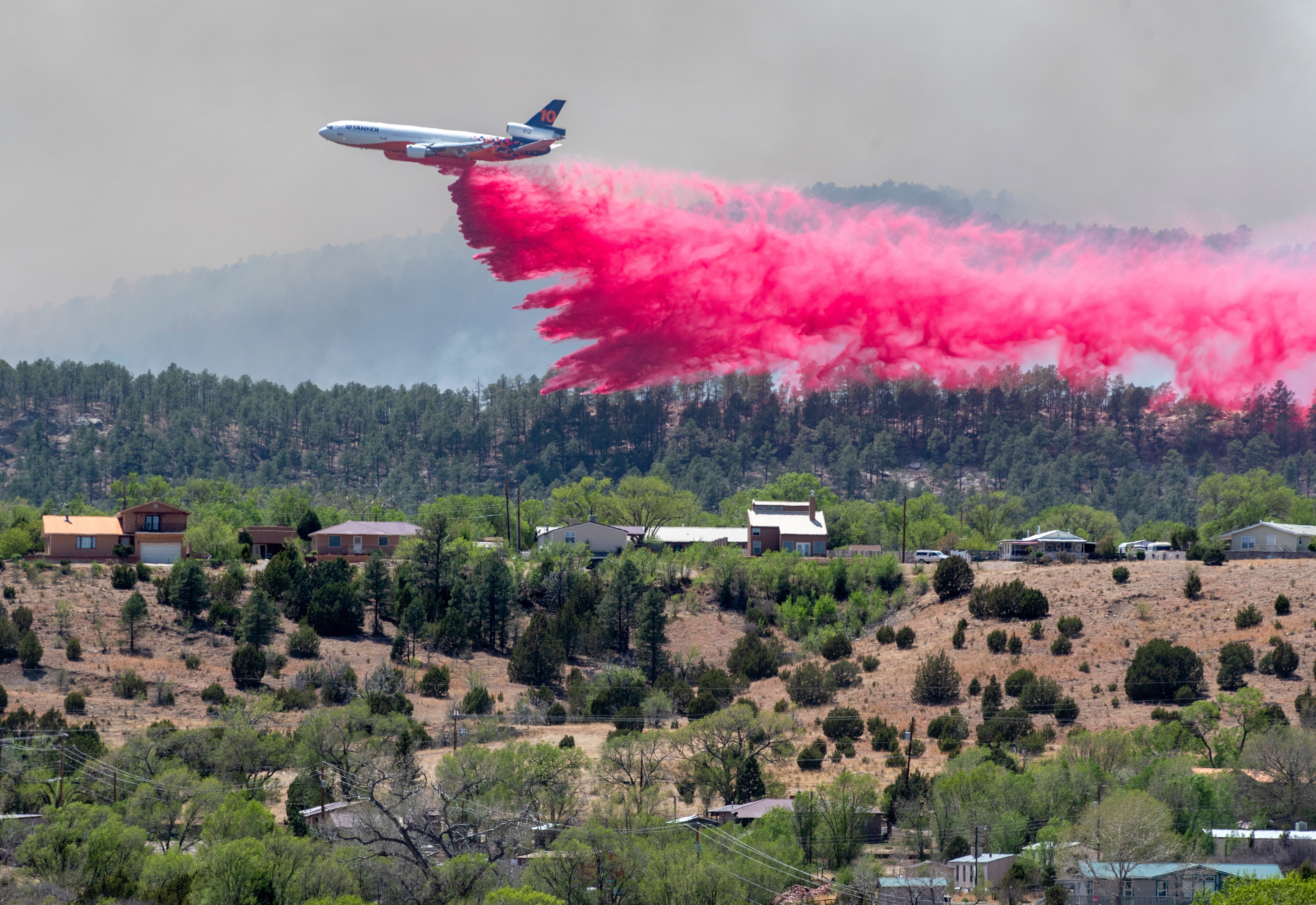 Firefighting aircraft like this slurry bomber (dropping fire retardant) are helping to keep the ongoing Calf Canyon/Hermits Peak fire from burning through Las Vegas, NM. (Photo: Eddie Moore, AP)