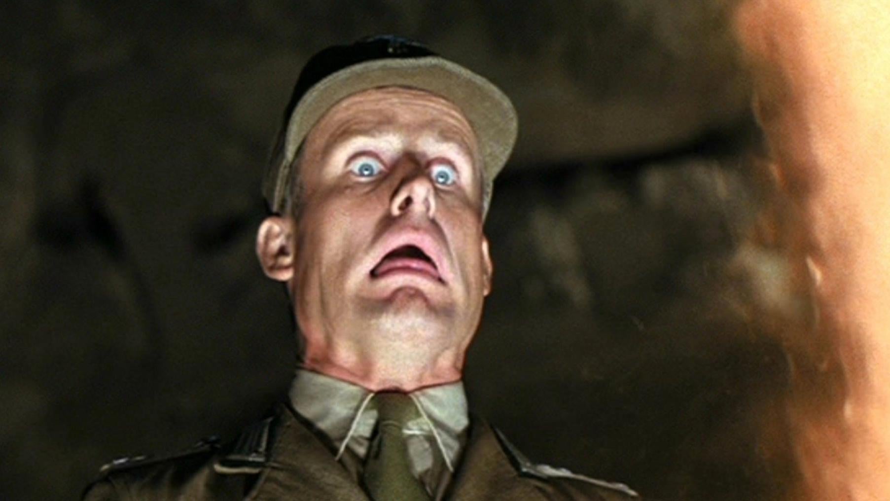 This man's face is about to melt in the PG Raiders of the Lost Ark. (Image: Paramount)