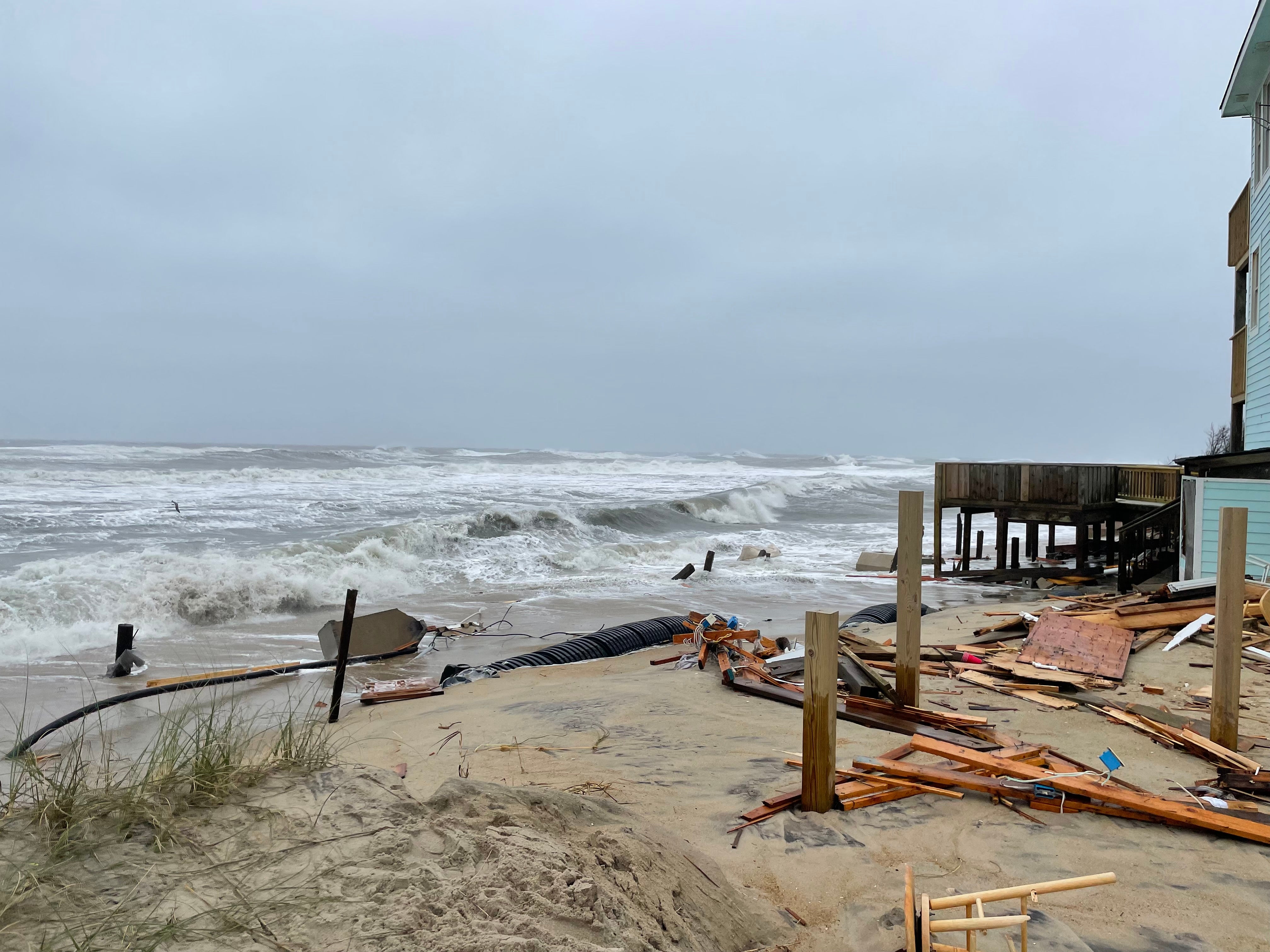 In the aftermath of the house collapses, the beaches are closed for cleanup. Extensive debris, including electrical wiring and septic tank piping, litters the shoreline. (Photo: Cape Hatteras NPS / National Park Service, Fair Use)