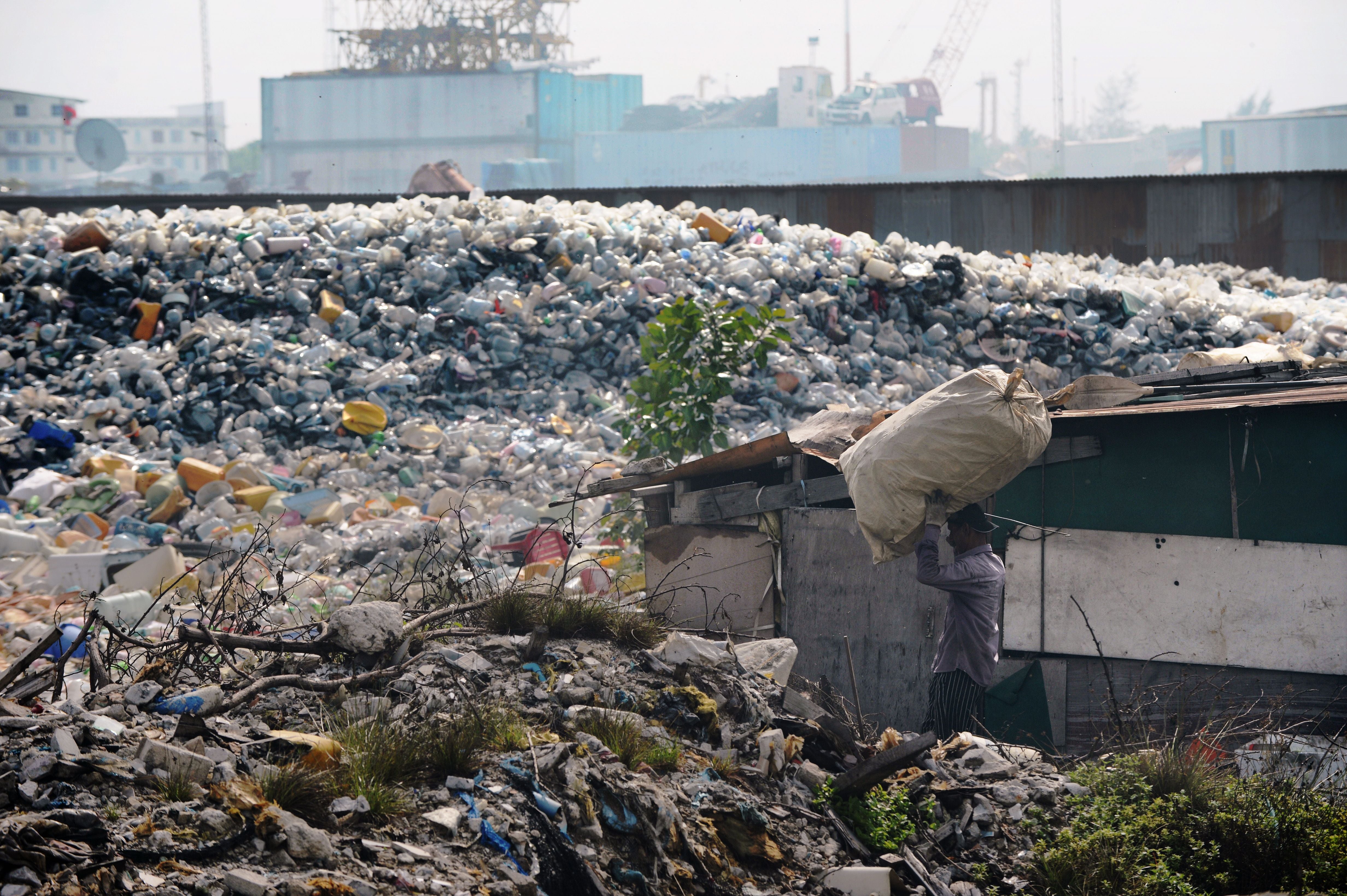 In this September 2013 photo, a Bangladeshi immigrant named Fusin carries a sack of recyclables. (Photo: Roberto Schmidt/AFP, Getty Images)