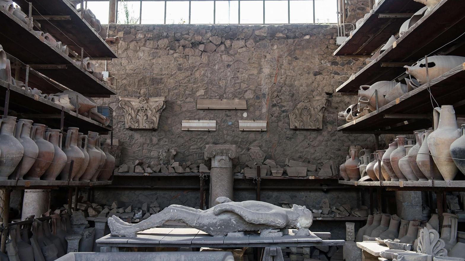 A body cast and amphorae in a storage area in Pompeii. (Photo: Giorgio Cosulich, Getty Images)