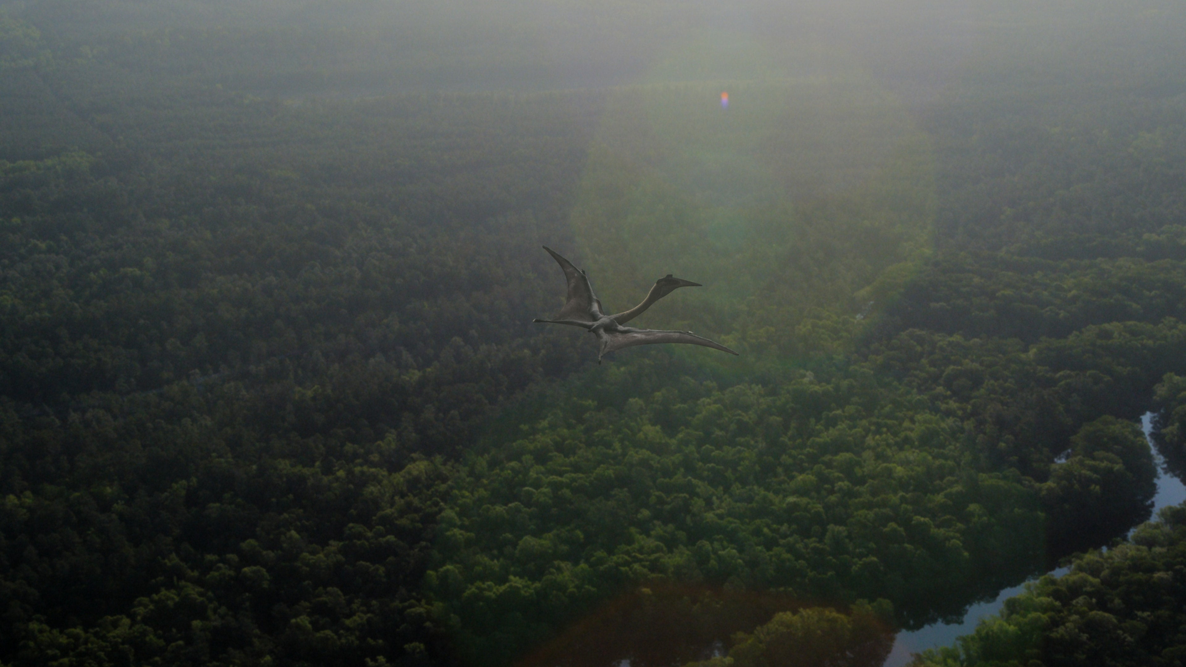 Quetzalcoatlus — the largest-known pterosaur — flies over a forest. (Image: Apple)