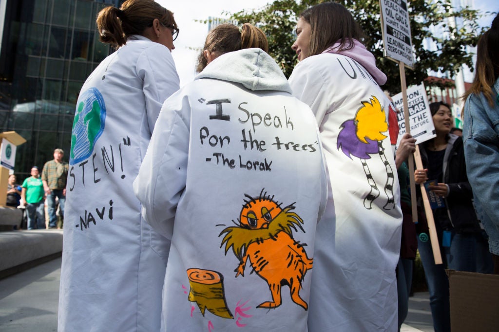 A student protestor wears a lab coat quoting the Lorax by Dr. Seuss during a climate protest in 2019. (Photo: JASON REDMOND/AFP, Getty Images)