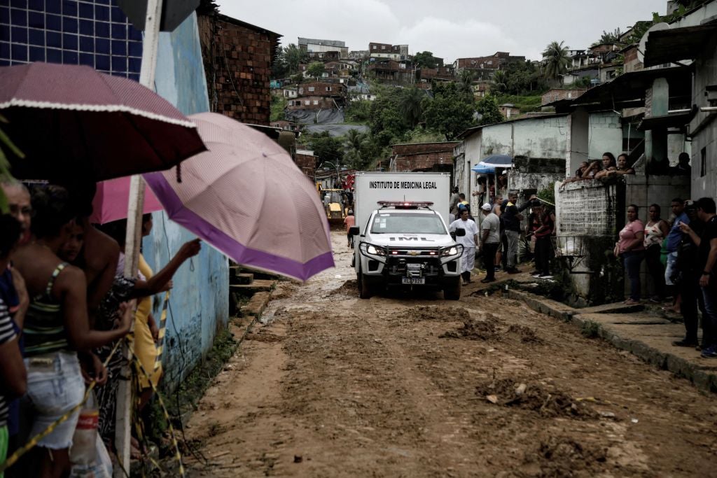 A vehicle of the forensic institute leaves with the body of a victim recovered from the mud a day after a landslide in Recife, Brazil.  (Photo: BRENDA ALCANTARA/AFP, Getty Images)