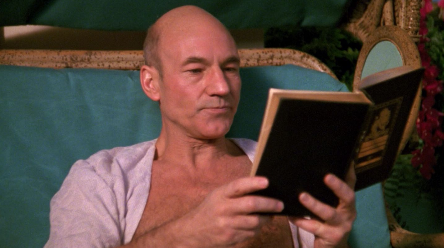 The episode is absolutely 100% about Picard reading this book with his chest on display, absolutely, nothing else happens. (Screenshot: Paramount)
