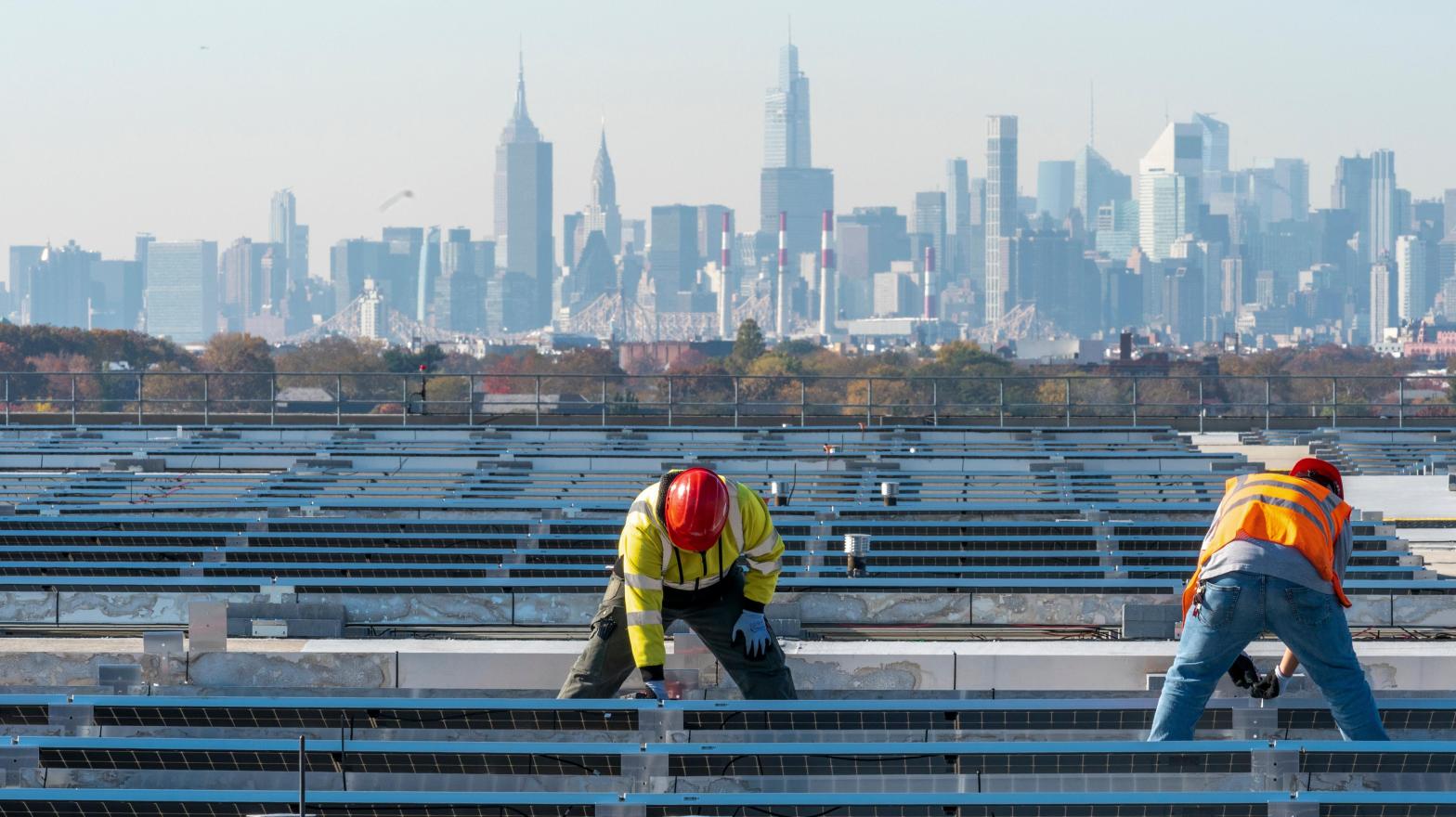 IBEW Local 3 workers install a solar panel on top of LaGuardia Airport in New York City.  (Photo: Mary Altaffer, AP)