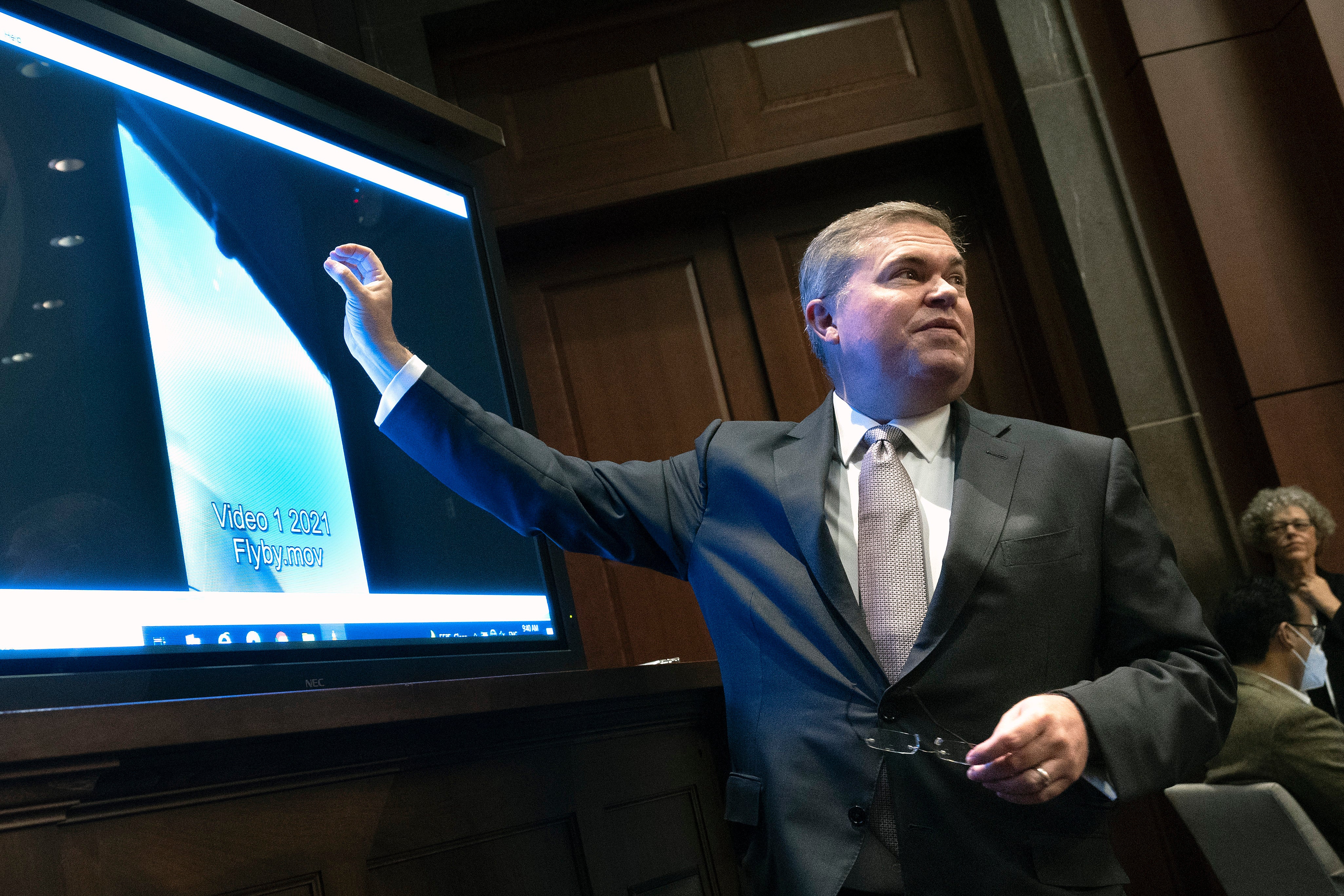 The U.S. Deputy Director of Naval Intelligence Scott Bray talks through a UAP video at a Congressional hearing. (Photo: Kevin Dietsch, Getty Images)