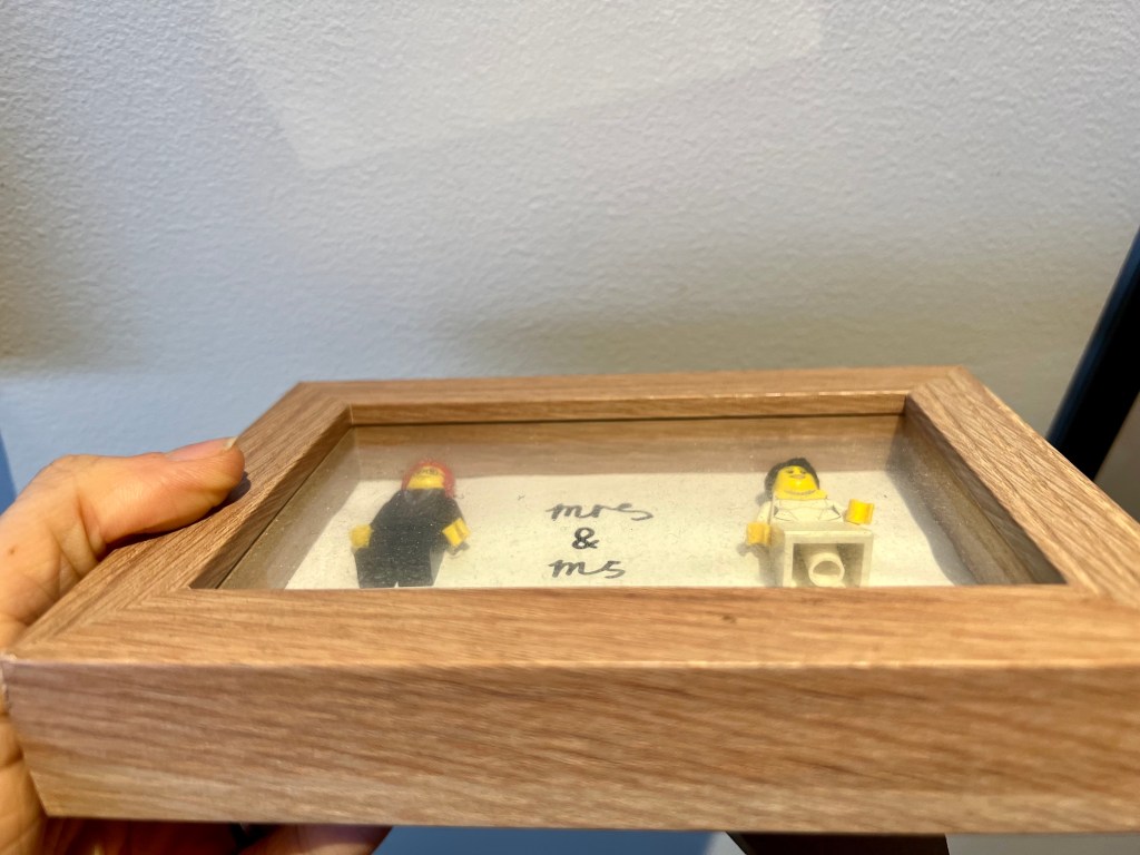 A dusty picture frame with Lego figures used on my wedding cake