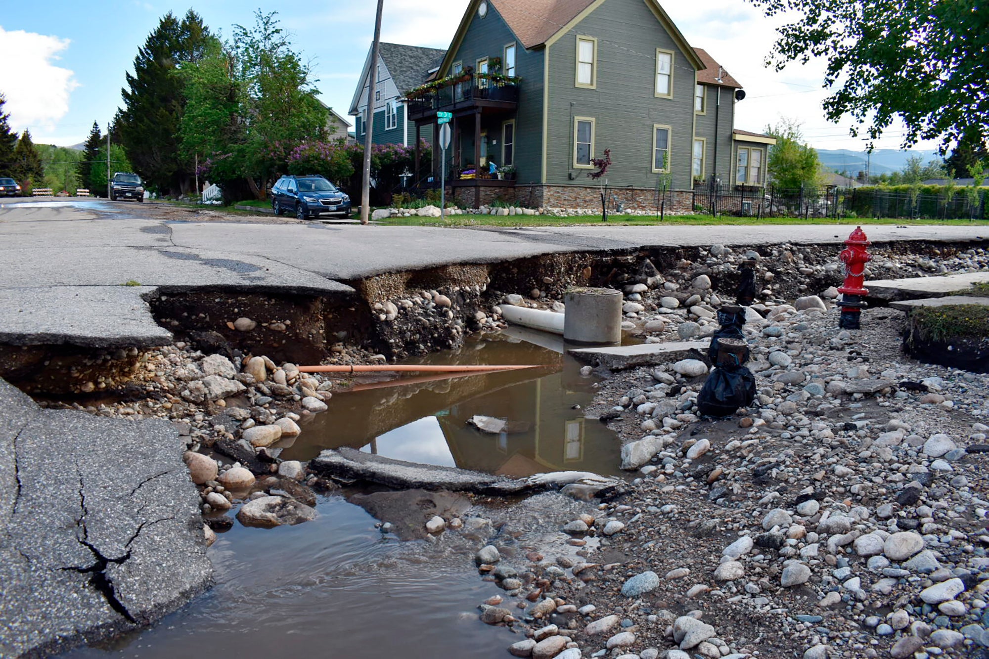 A street badly damaged by flooding is seen, Tuesday, June 14, 2022, in Red Lodge, Mont. (Photo: Matthew Brown, AP)