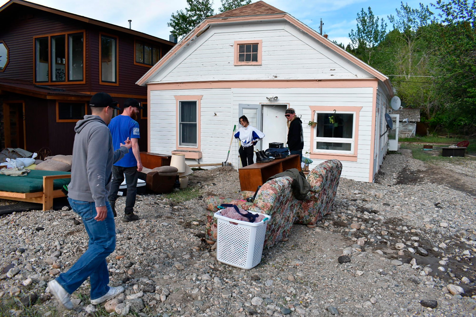 Residents of Red Lodge, Mont., inspect damage to a house that was  flooded after torrential rains fell across the Yellowstone region,  Tuesday, June 14, 2022.  (Photo: Matthew Brown, AP)
