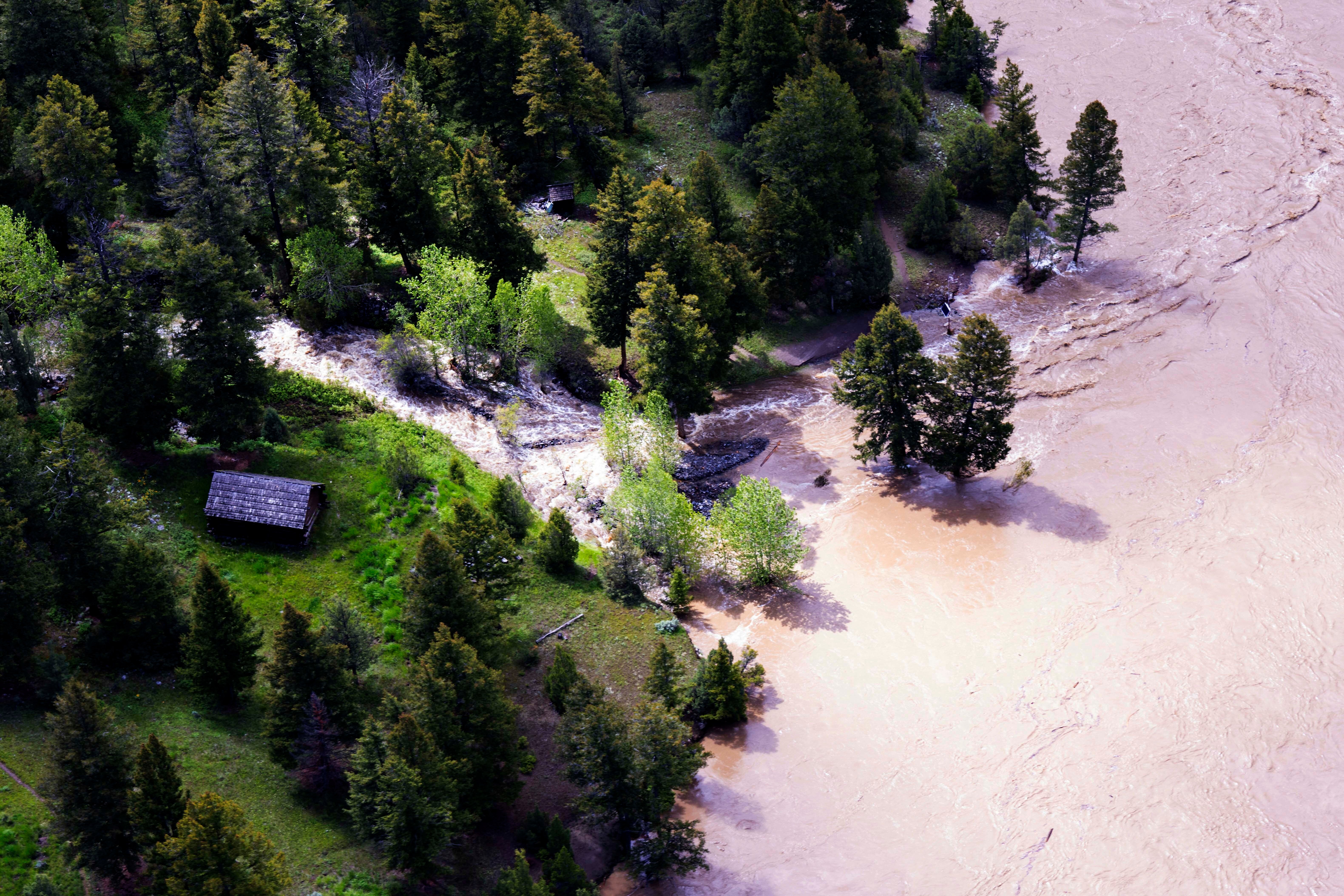 This aerial photo provided by the National Park Service shows the Lower  Blacktail Patrol Cabin washed away in Yellowstone National Park on  Monday, June 13, 2022.  (Photo: Jacob W. Frank/National Park Service, AP)