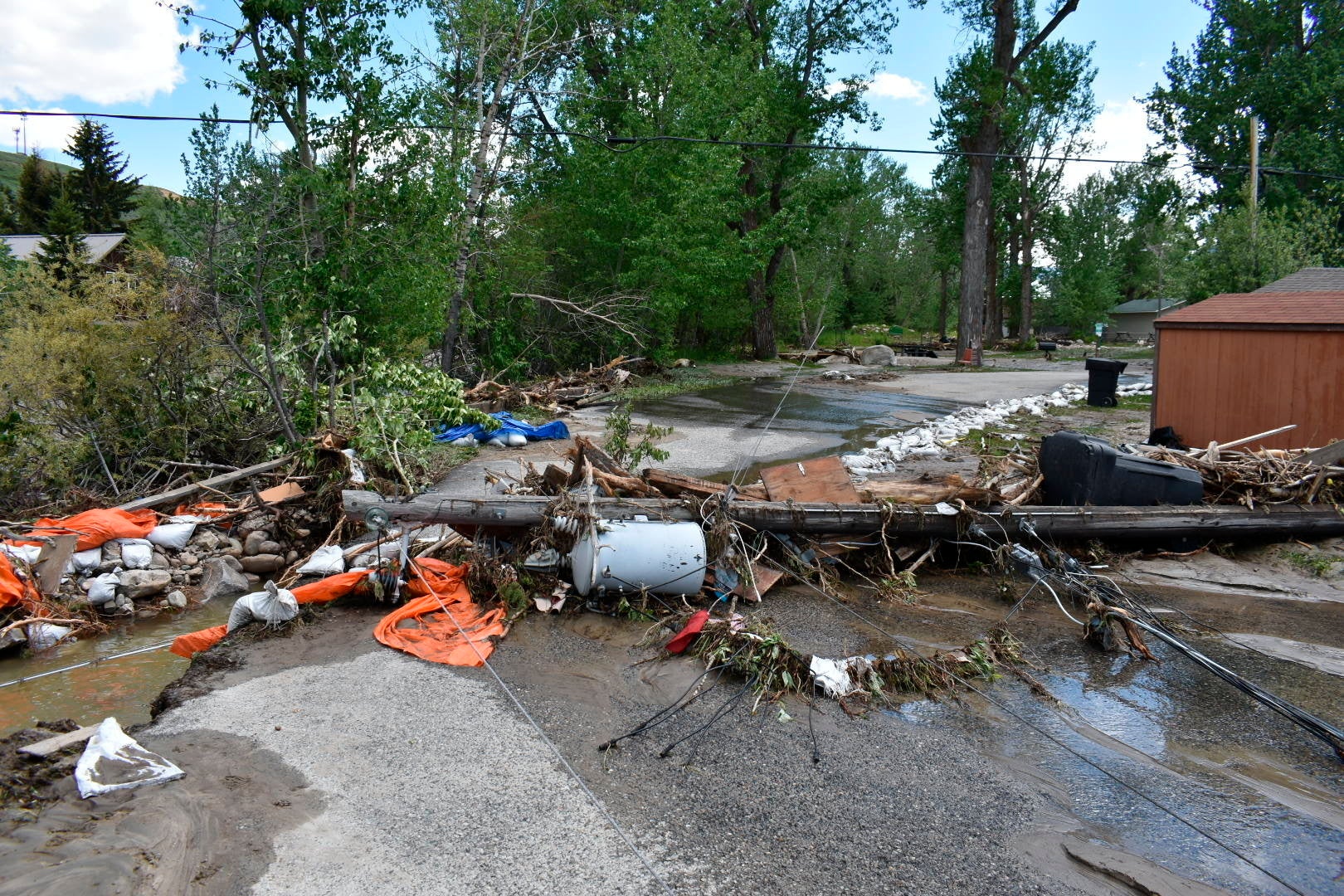 Debris is seen blocking a street in Red Lodge, Montana, on Tuesday, June  14, 2022, after floodwaters coursed through a neighbourhood with  hundreds of houses the day before. (Photo: Matthew Brown, AP)