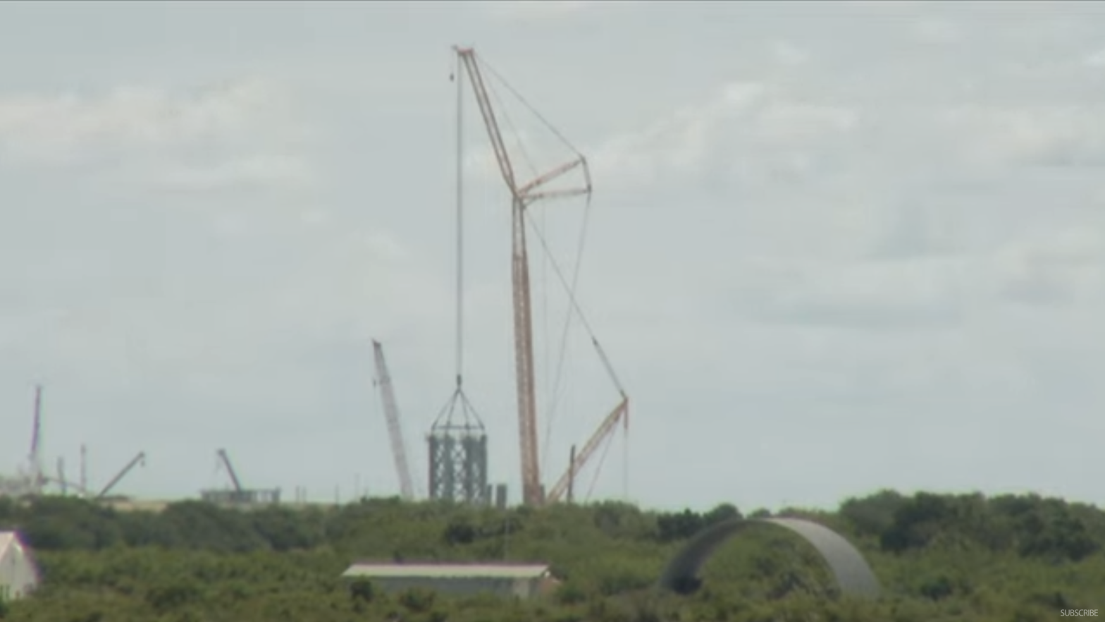 Earlier today, a crane creating the first stack for a tower that will eventually reach more than 121.92 m in height.   (Screenshot: Spaceflight Now/YouTube)