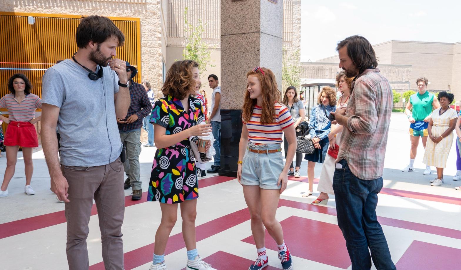 The Duffer Brothers (with Millie Bobby Brown and Sadie Sink) are deeping their Netflix roots. (Image: Netflix)