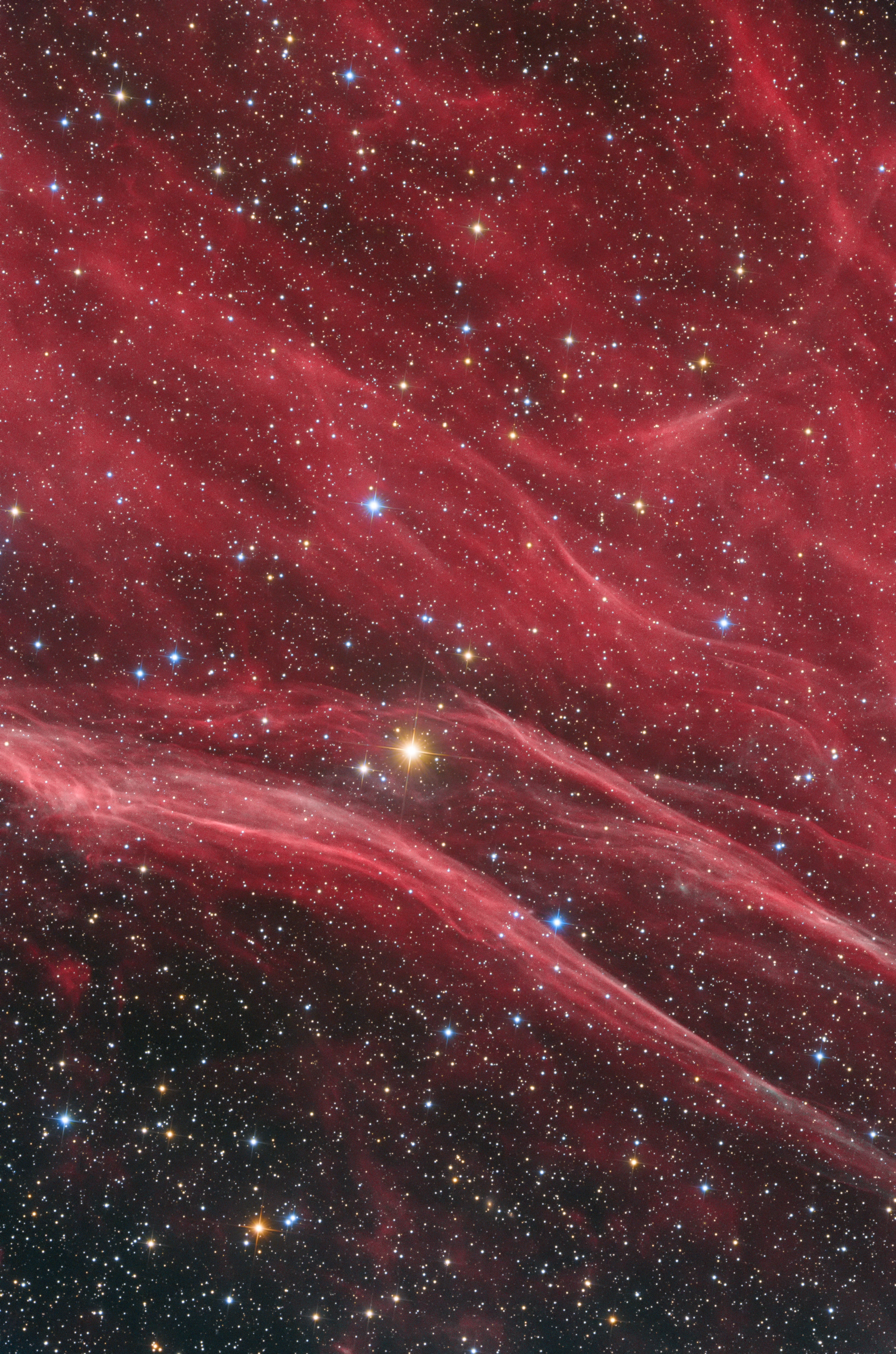 The wispy reds of a supernova remnant. (Image: © Paul Milvain)