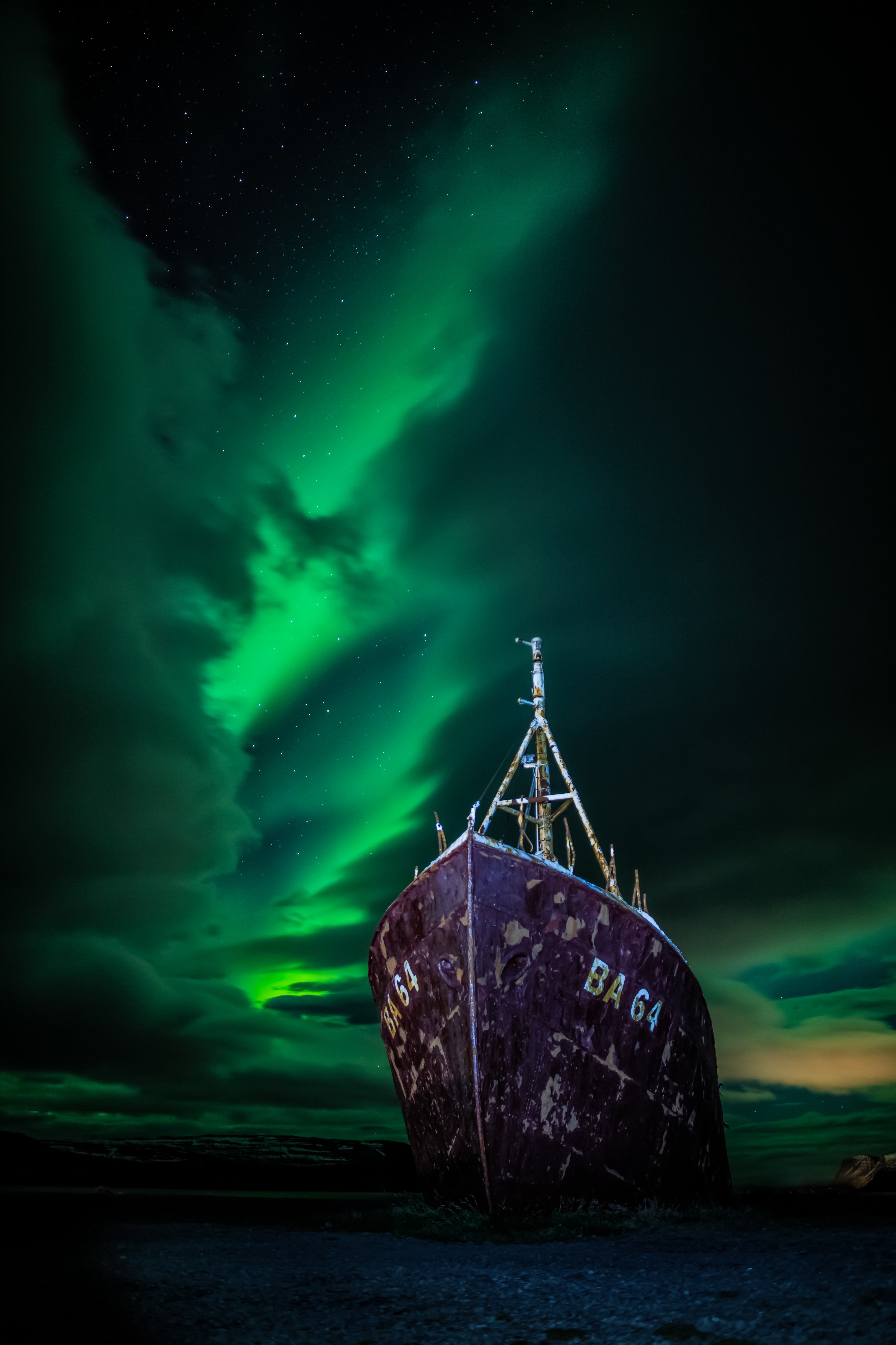 A shipwreck sits in the foreground, with the Northern Lights above it.  (Photo: © Carl Gallagher)