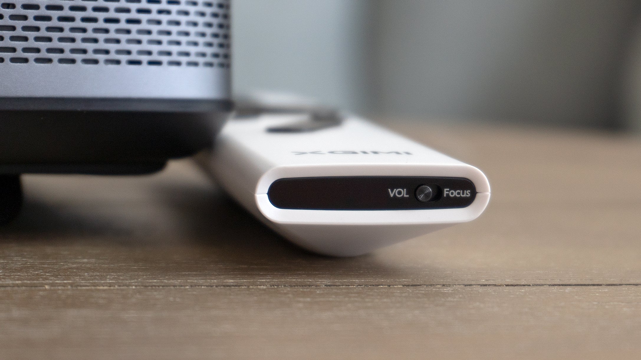 Quickly accessing manual focus controls on the XGIMI Halo+'s remote involves flipping a toggle switch hidden on the bottom edge of the remote. (Photo: Andrew Liszewski | Gizmodo)