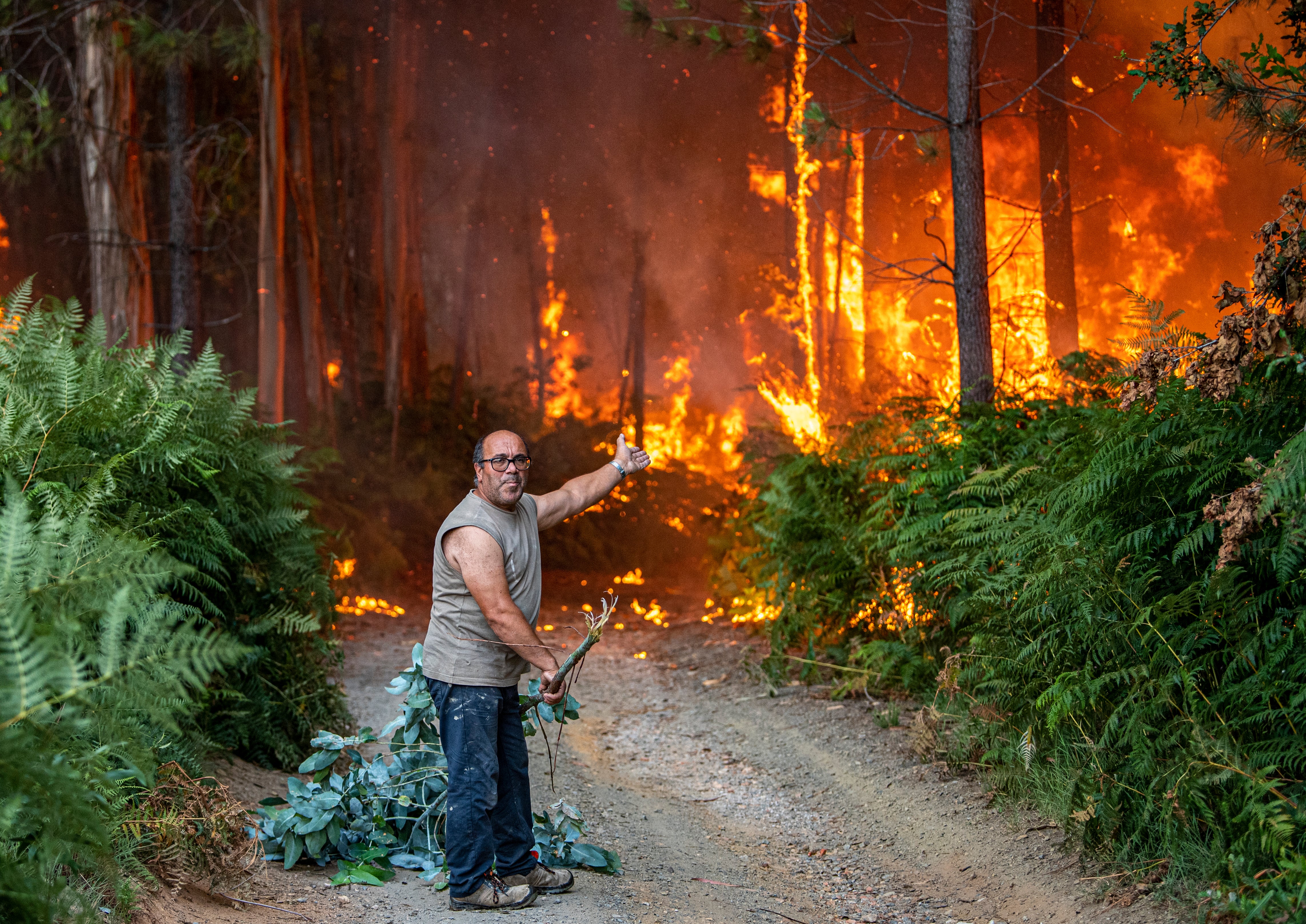 A resident reacts to a fire burning near his home in Albergaria a Velha, Portugal, on July 13, 2022. (Photo: Octavio Passos, Getty Images)