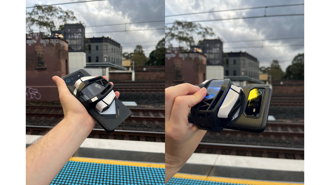 holding phone over train tracks for some reason