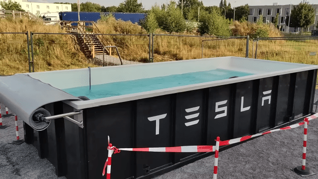 Tesla Wants You To Sit in a Wet Dumpster While Your Car Charges