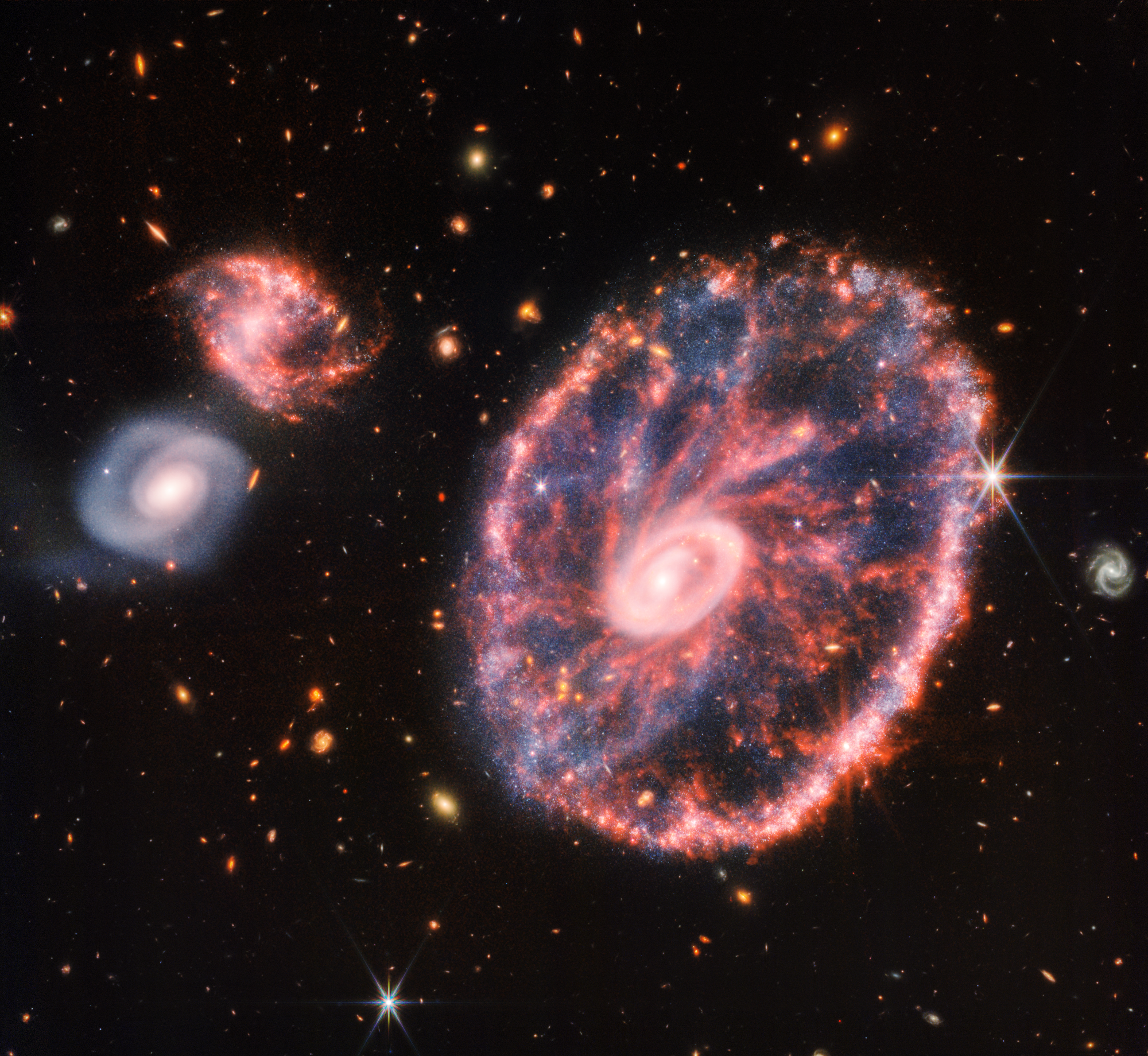 The Cartwheel Galaxy looks a bit like a wagon wheel. (Image: NASA, ESA, CSA, STScI)