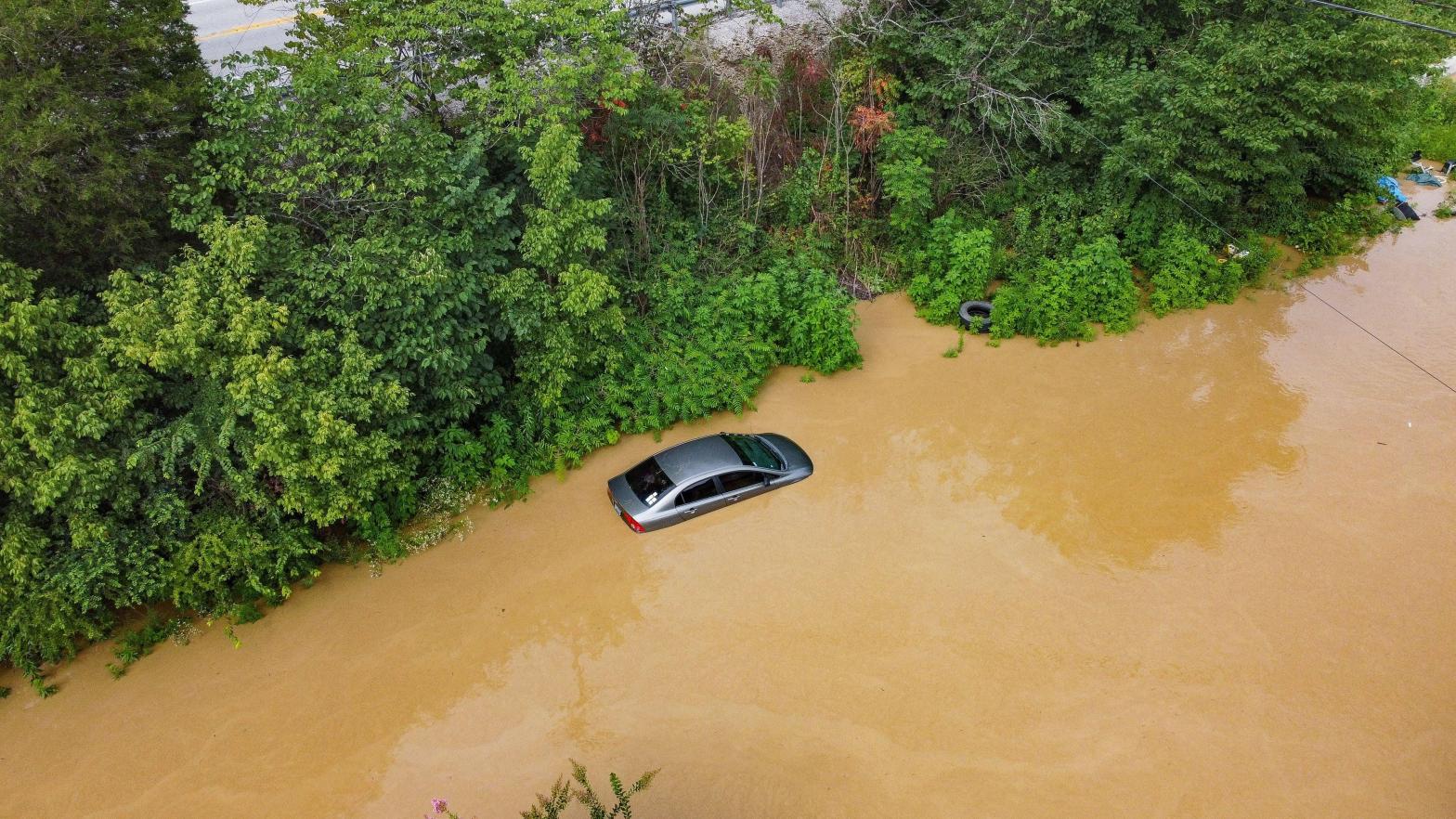 Aerial view of a car on a road submerged under flood waters from the North Fork of the Kentucky River in Jackson, Kentucky, on July 28, 2022. (Photo: LEANDRO LOZADA / AFP, Getty Images)