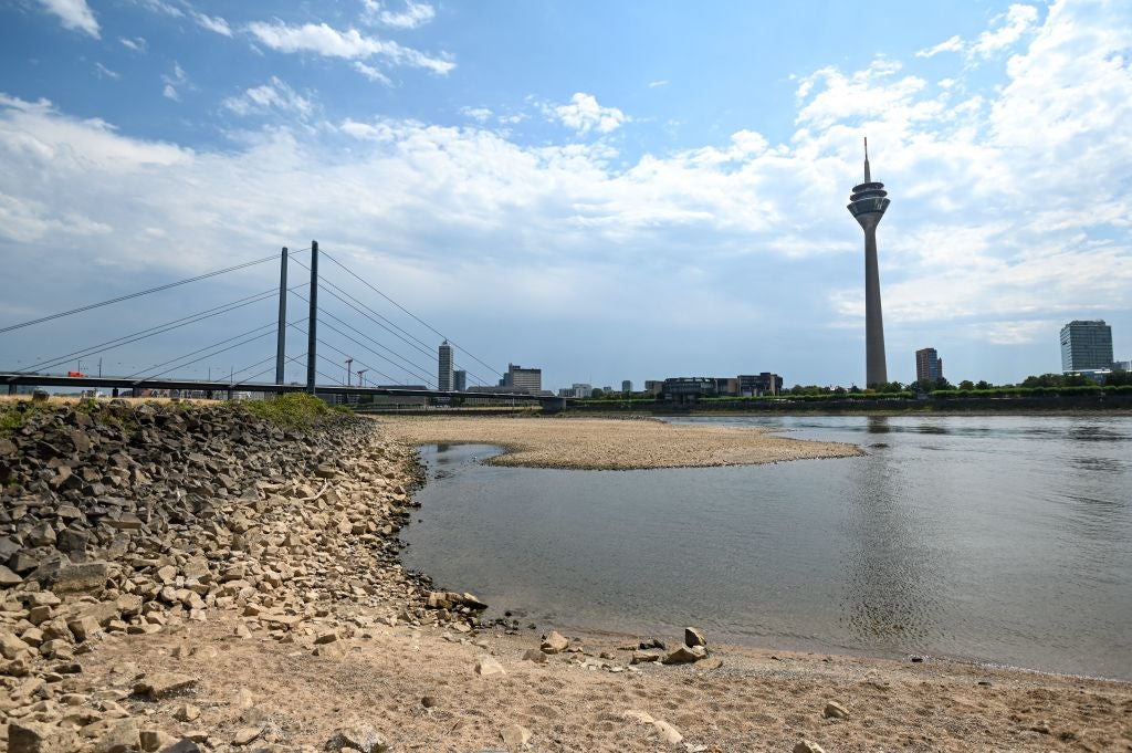 Dry soil of the partially dried-up river bed of the Rhine in Duesseldorf, Germany, in July 2022, as Europe experienced a heatwave. (Photo: INA FASSBENDER/AFP, Getty Images)